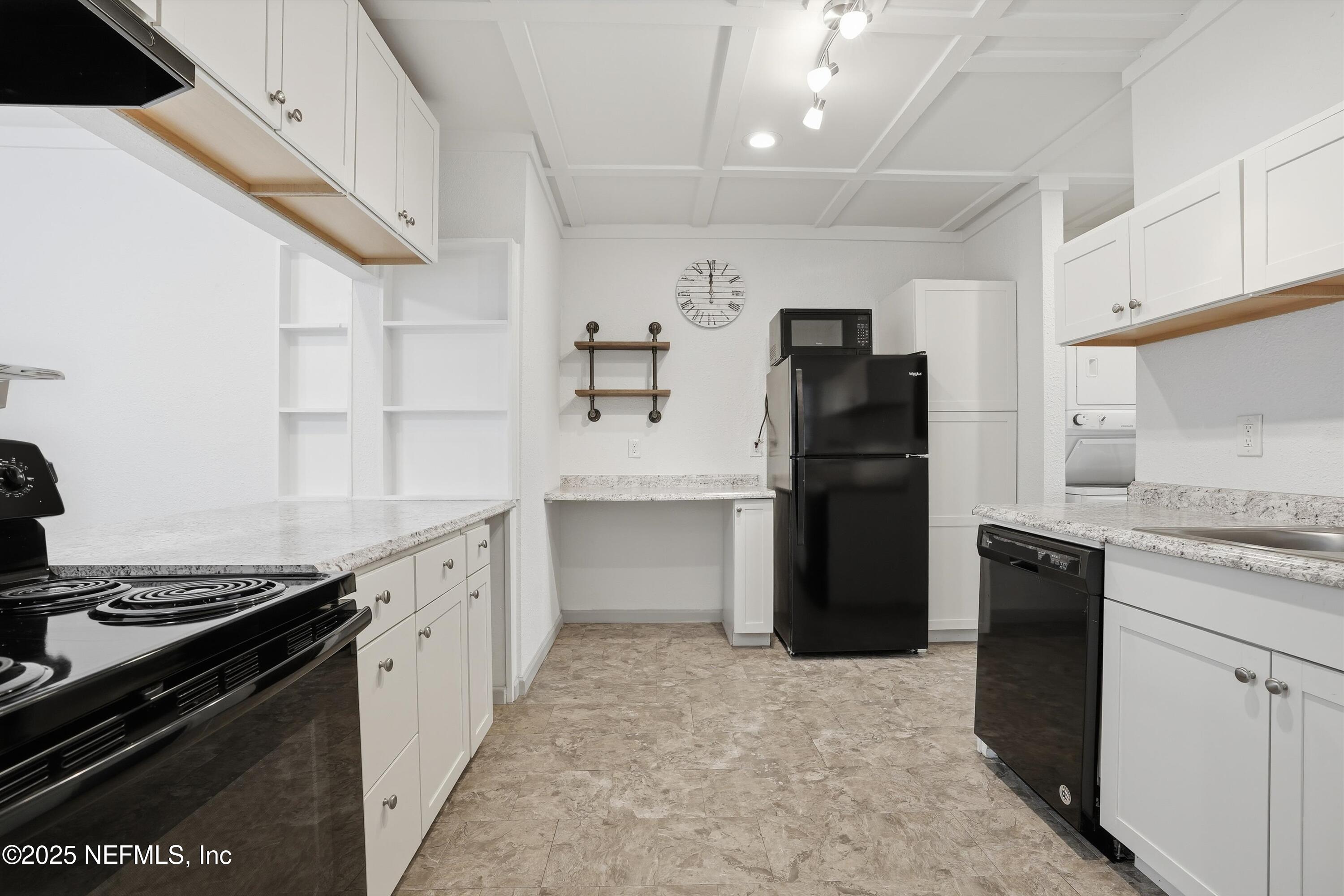 911 Phillips Street Jacksonville, FL 32207 - Photo 10 of 36 a kitchen with a refrigerator and a stove top oven