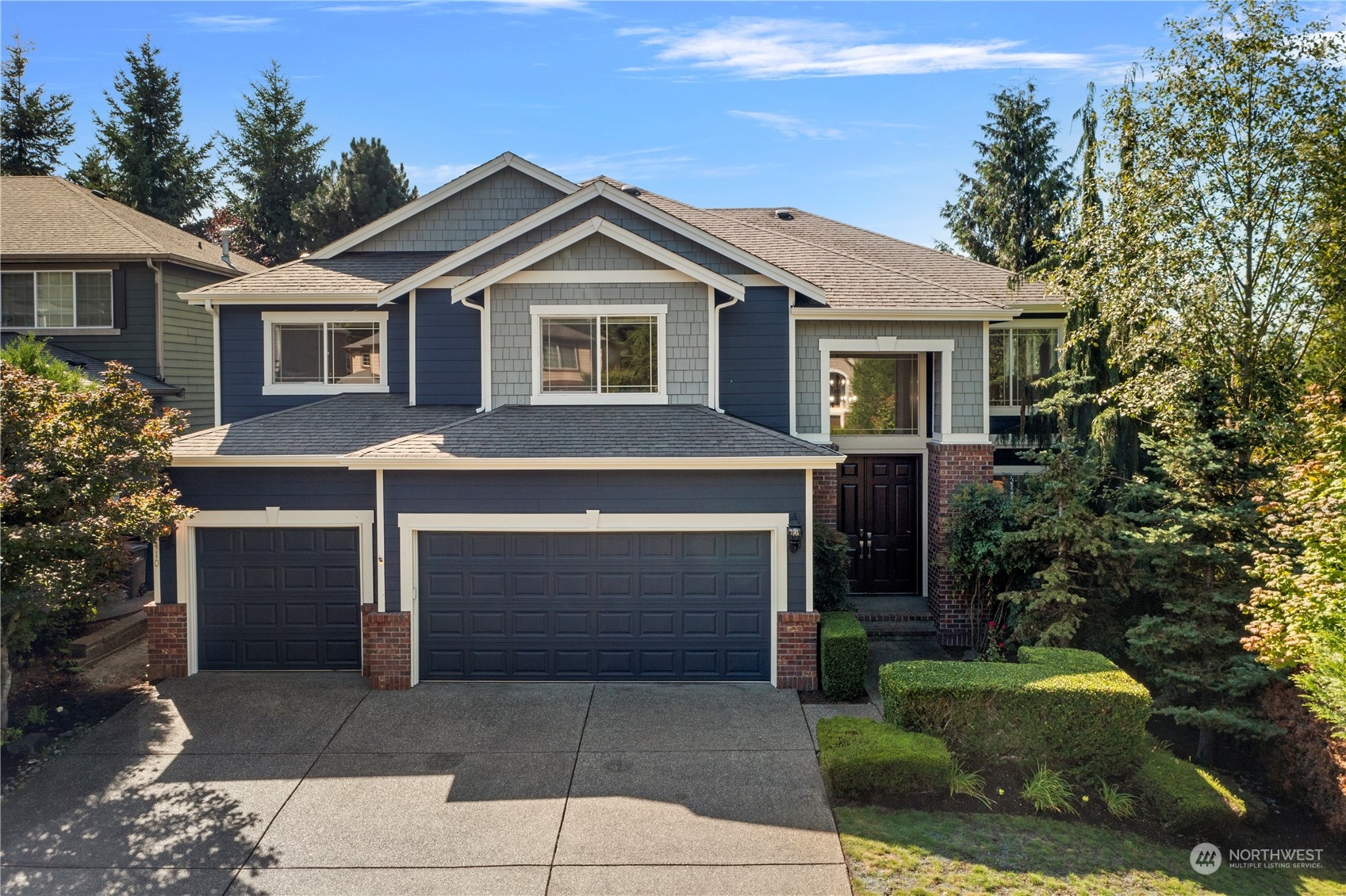 a front view of a house with a garden
