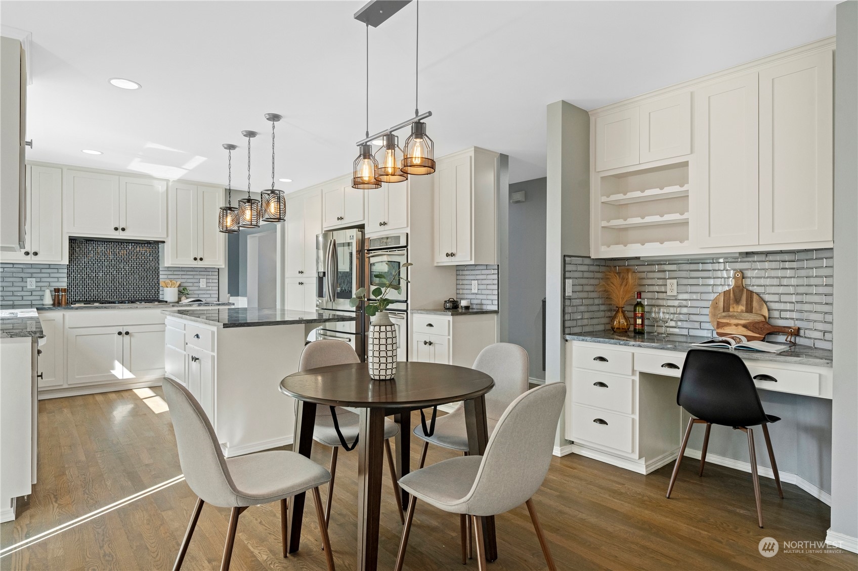 4410 239th Place Southeast Bothell, WA 98021 - Photo 12 of 40 a kitchen with stainless steel appliances kitchen island granite countertop a dining table chairs and a refrigerator