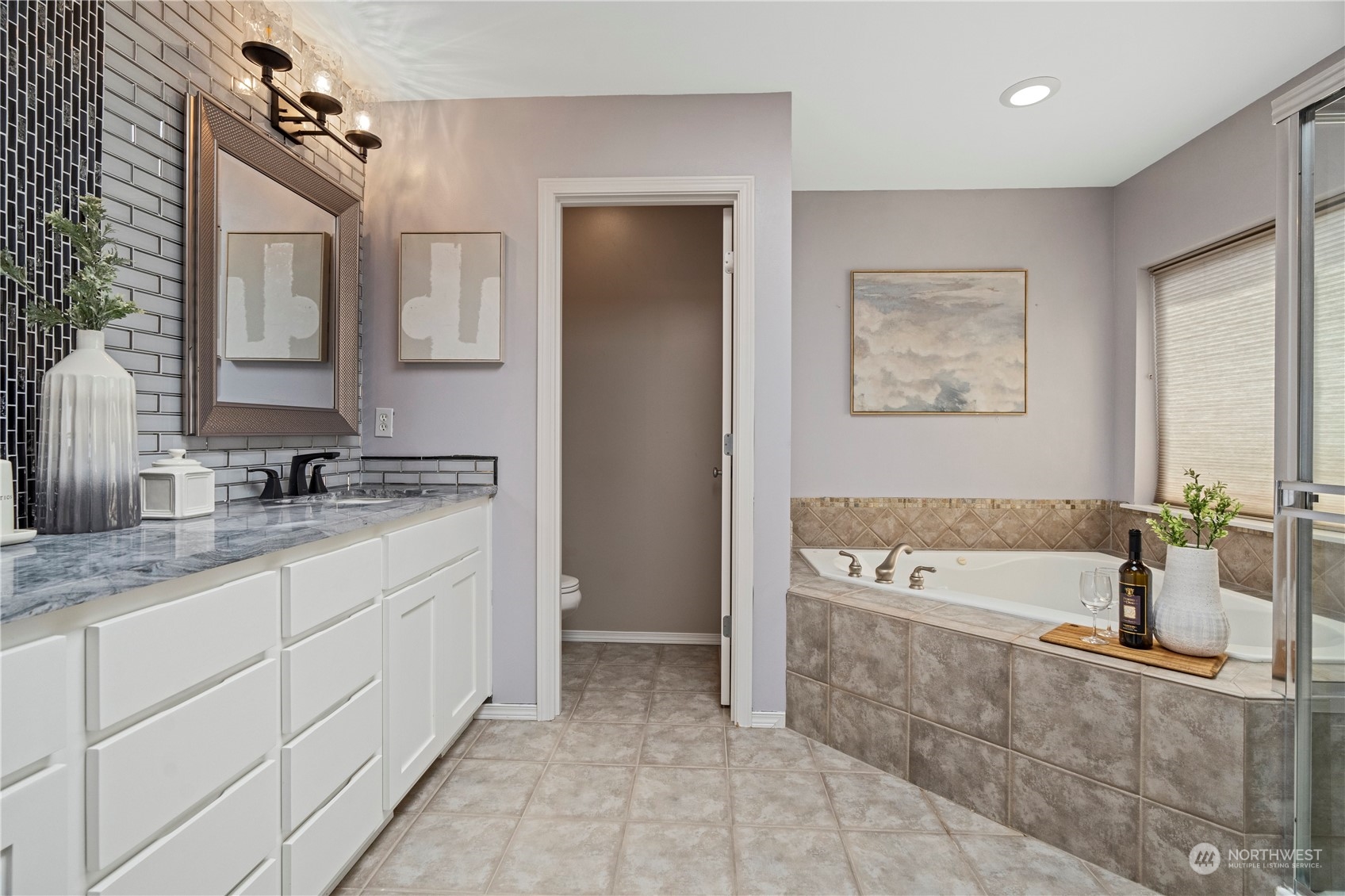 4410 239th Place Southeast Bothell, WA 98021 - Photo 25 of 40 a spacious bathroom with a tub sink and mirror