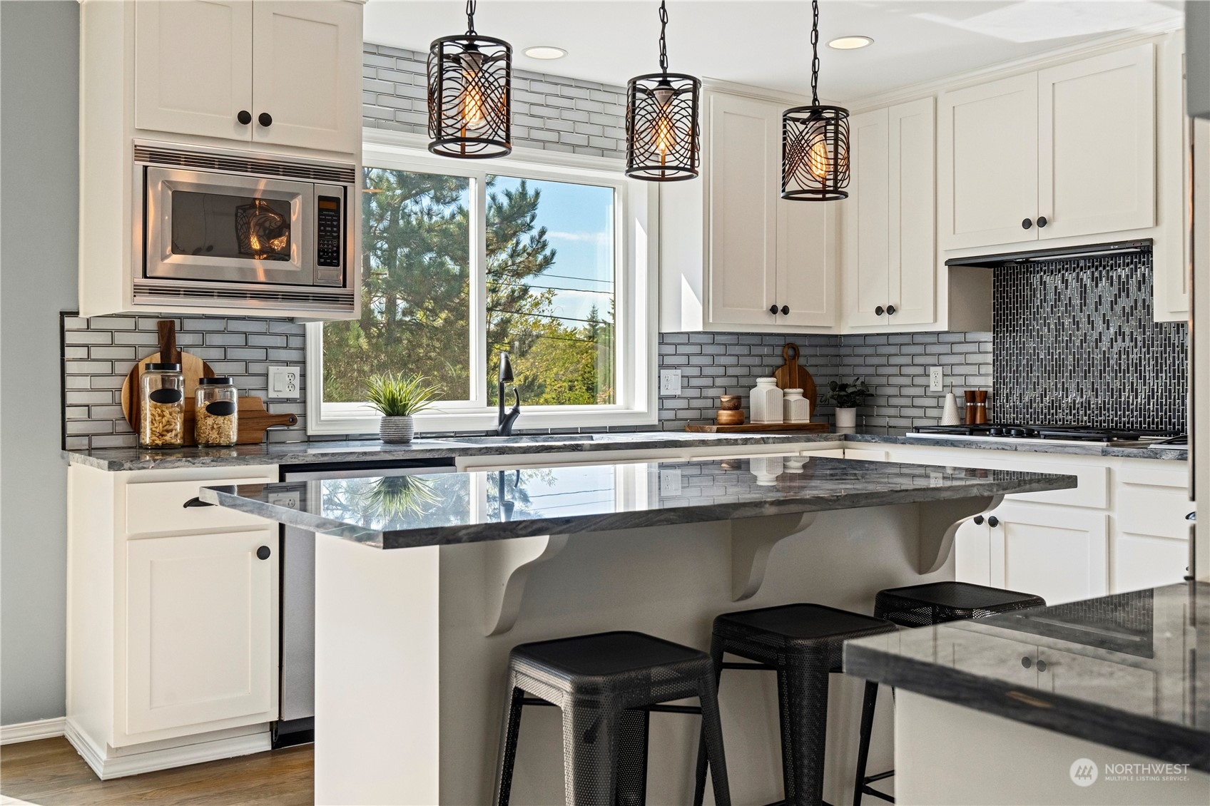 4410 239th Place Southeast Bothell, WA 98021 - Photo 10 of 40 a kitchen with stainless steel appliances granite countertop a stove a sink and white cabinets