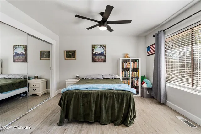 a bedroom with a bed a couch and dresser