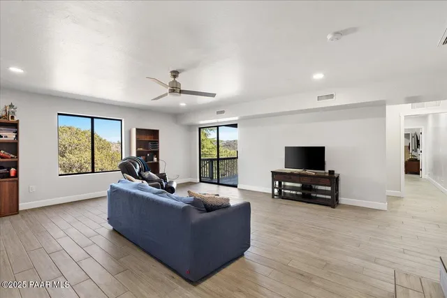 a living room with furniture and a wooden floor