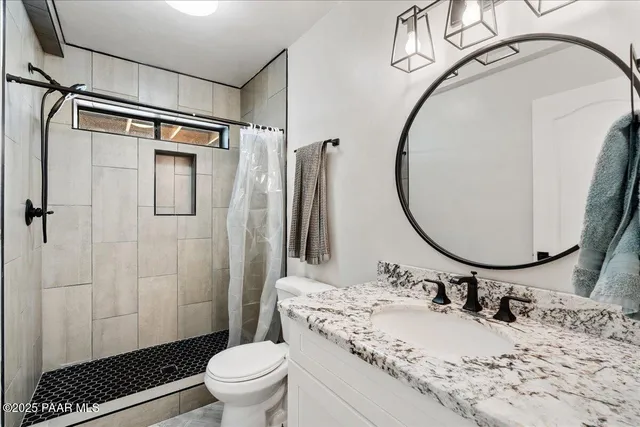 a bedroom with a bed and a ceiling fan