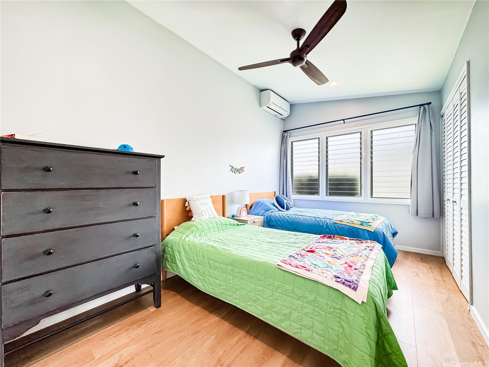 346 Ilimalia Loop Kailua, HI 96734 - Photo 11 of 24 a bedroom with a bed and large windows