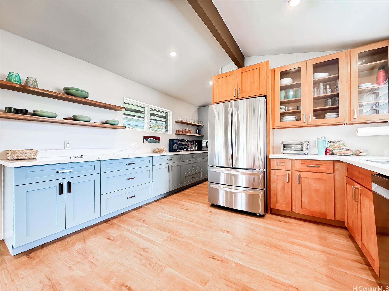 346 Ilimalia Loop Kailua, HI 96734 - Photo 4 of 24 a kitchen with granite countertop stainless steel appliances a refrigerator and wooden cabinets