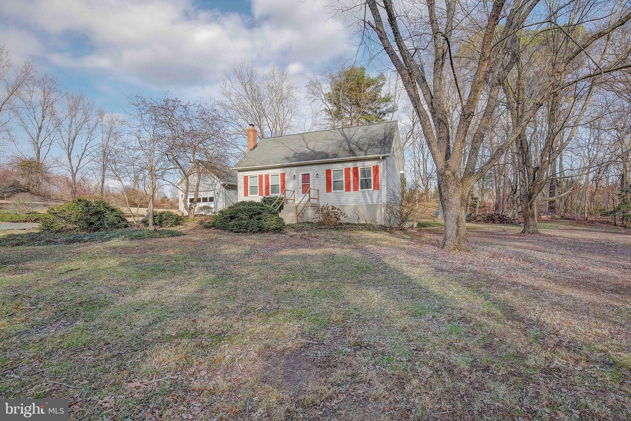 9150 Mackall Road St. Leonard, MD 20685 - Photo 5 of 48 a view of house with yard and trees in the background