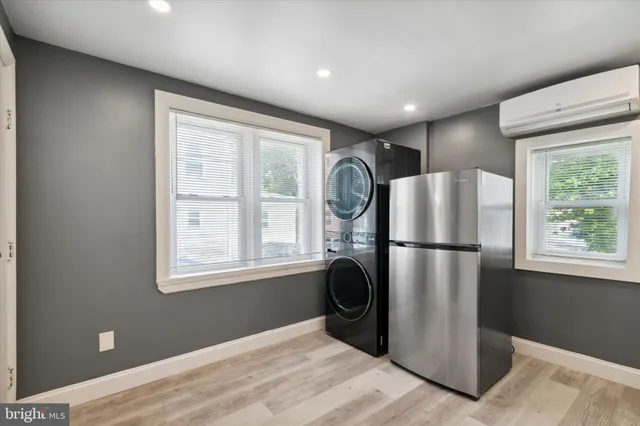 a view of kitchen with furniture refrigerator and window