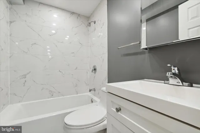 a bathroom with a sink a toilet and a bathtub