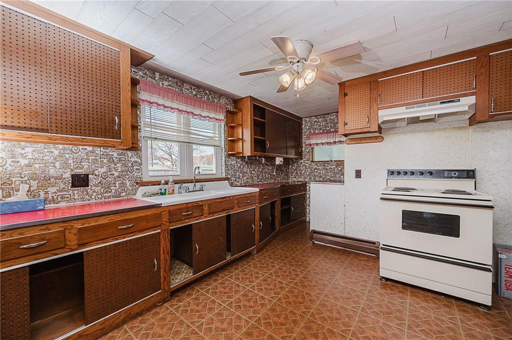 151 Hemlock Road Commodore, PA 15729 - Photo 13 of 50 a kitchen with stainless steel appliances granite countertop a stove and a sink