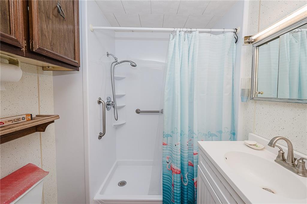 151 Hemlock Road Commodore, PA 15729 - Photo 16 of 50 a bathroom with a sink a mirror and shower