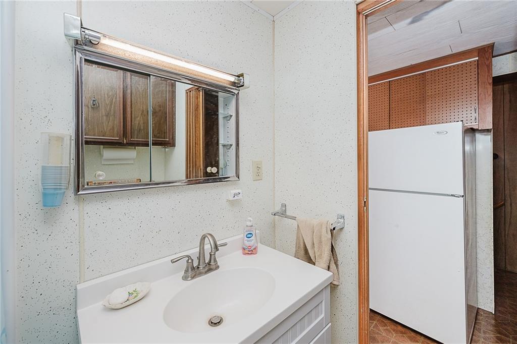151 Hemlock Road Commodore, PA 15729 - Photo 17 of 50 a bathroom with a sink and a mirror