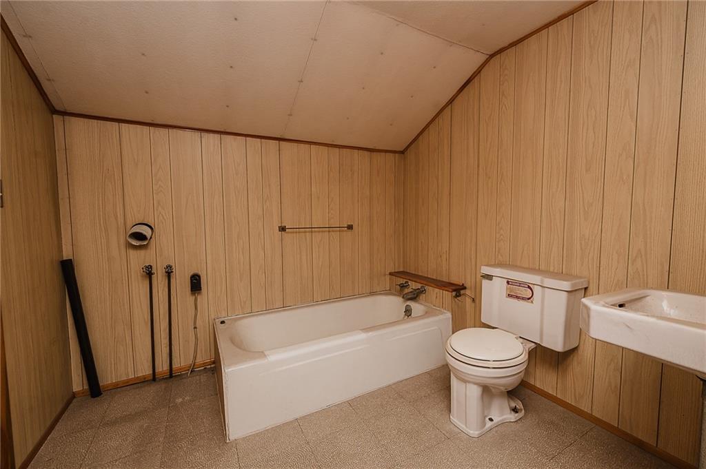 151 Hemlock Road Commodore, PA 15729 - Photo 36 of 50 a white toilet sitting next to a bathroom sink and tub