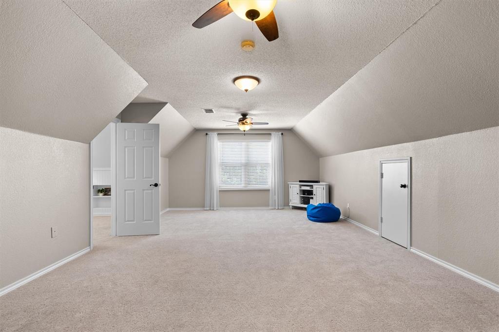 410 Simmons Road Double Oak, TX 75077 - Photo 24 of 40 Generous game room with soaring ceilings perfect for family gatherings.