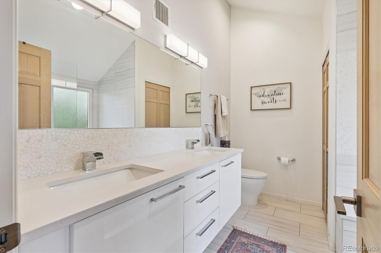 23666 Pondview Place, Unit H Golden, CO 80401 - Photo 14 of 19 a spacious bathroom with a toilet sink and mirror