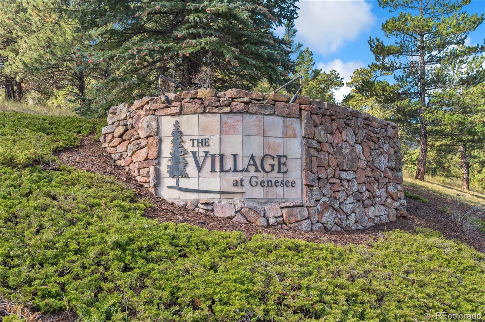 23666 Pondview Place, Unit H Golden, CO 80401 - Photo 19 of 19 a sign that is sitting in front of a tree