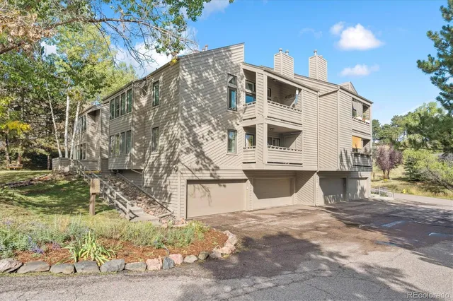 a view of a white building among the street with palm trees