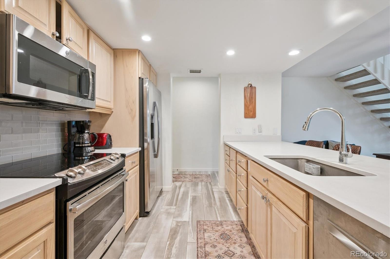 23666 Pondview Place, Unit H Golden, CO 80401 - Photo 6 of 19 a kitchen with stainless steel appliances granite countertop a sink and a stove