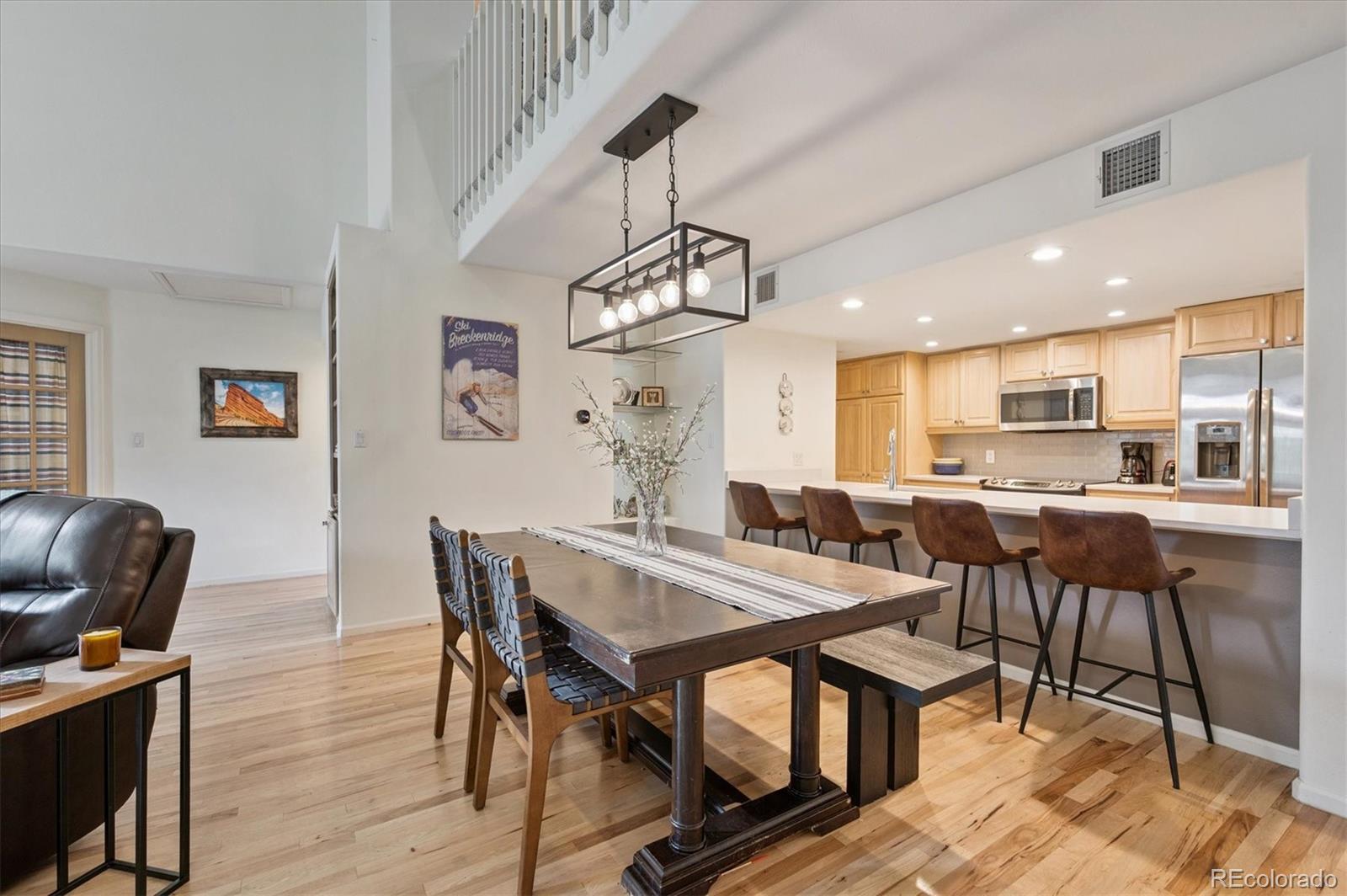 23666 Pondview Place, Unit H Golden, CO 80401 - Photo 8 of 19 a view of a dining room with furniture window and wooden floor