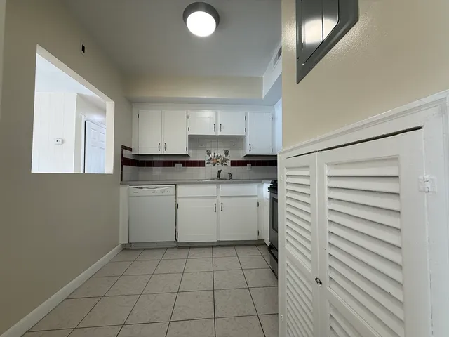 a kitchen with a stove a sink and a refrigerator