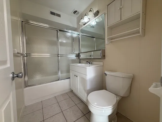 a bathroom with a toilet sink and a shower