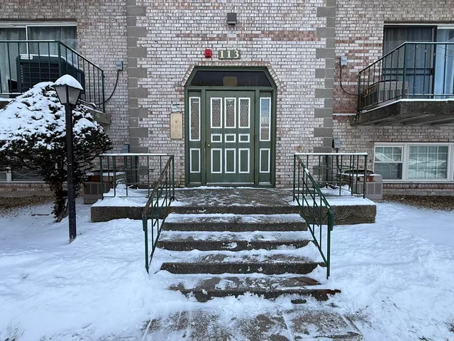 a view of front door of house with stairs