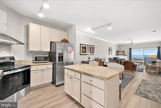 a kitchen with a stove a sink and a refrigerator