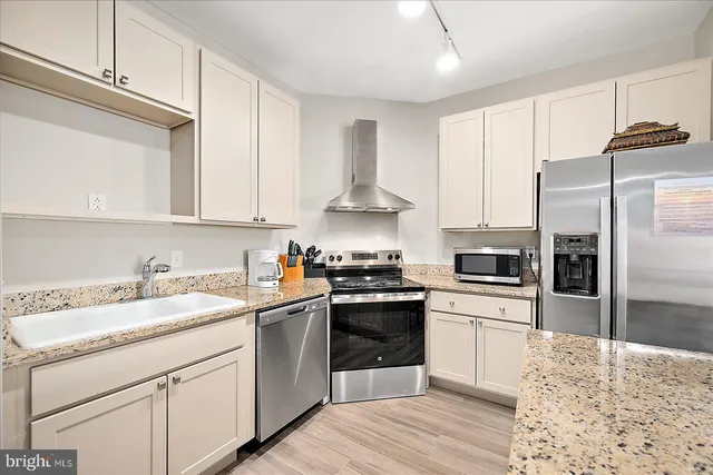 a kitchen with a sink stove and refrigerator