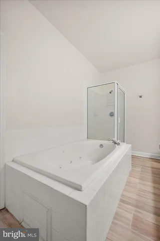 a bathroom with a tub sink and vanity