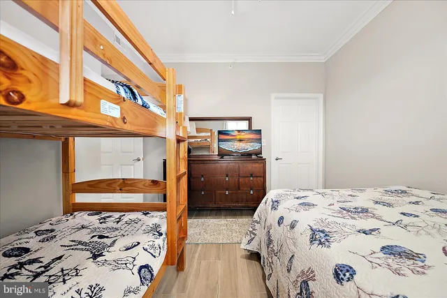 a bedroom with a bed and dresser with shower