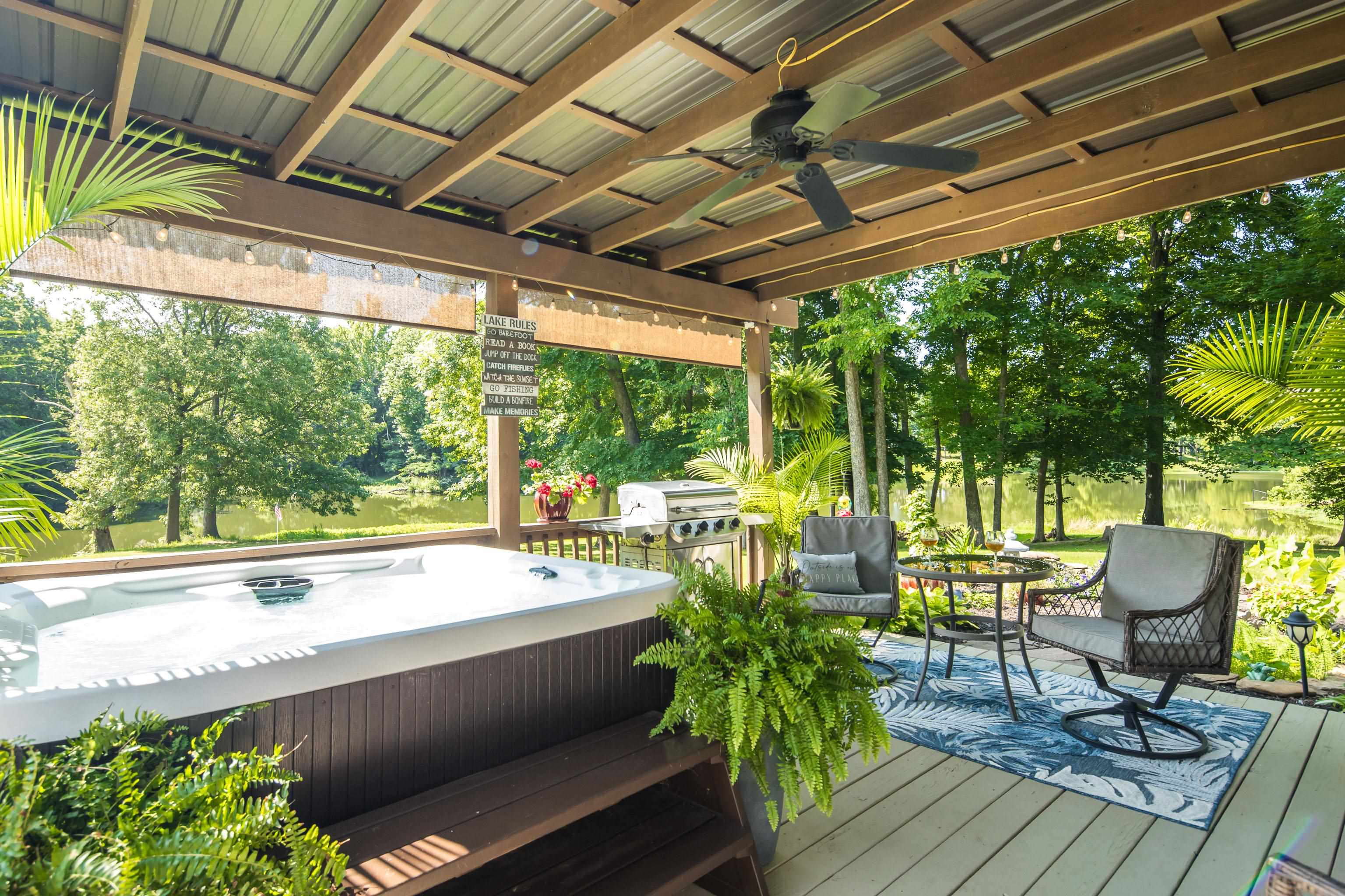 243 Hayes Road Munford, TN 38058 - Photo 6 of 25 Covered outdoor deck with hot tub perfect for enjoying lake view while grilling