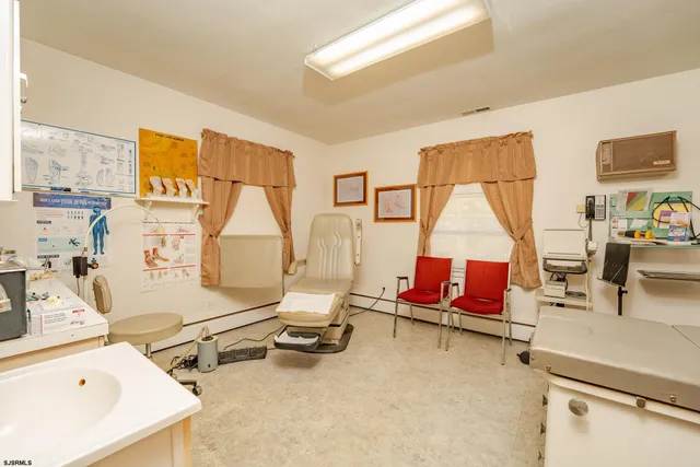 a living room with furniture a rug and white walls
