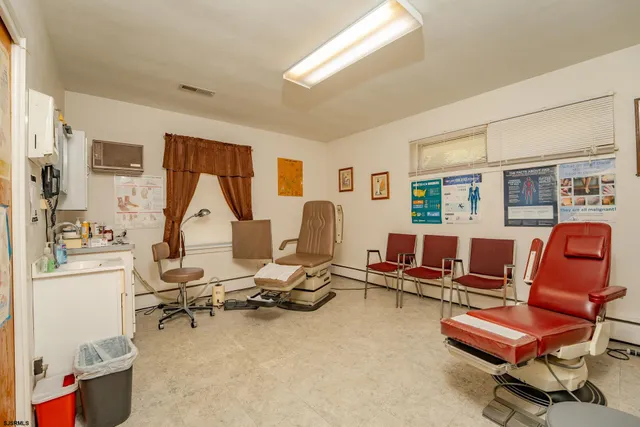 a living room with furniture a air conditioner vent and a window