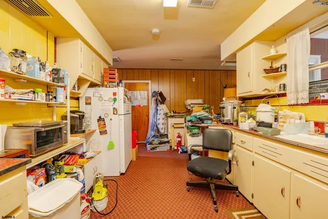 a view of a kitchen with workspace and a window