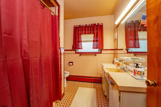 a bathroom with a sink a mirror and a shower