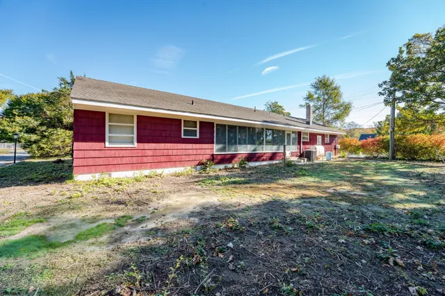 a front view of a house with a yard table and chairs