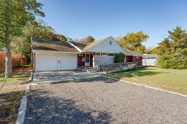 a front view of a house with a yard and a garage