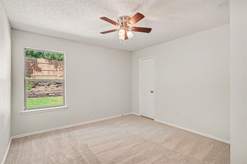 2541 Rivers Edge Drive Fort Worth, TX 76118 - Photo 20 of 31 an empty room with ceiling fan and window
