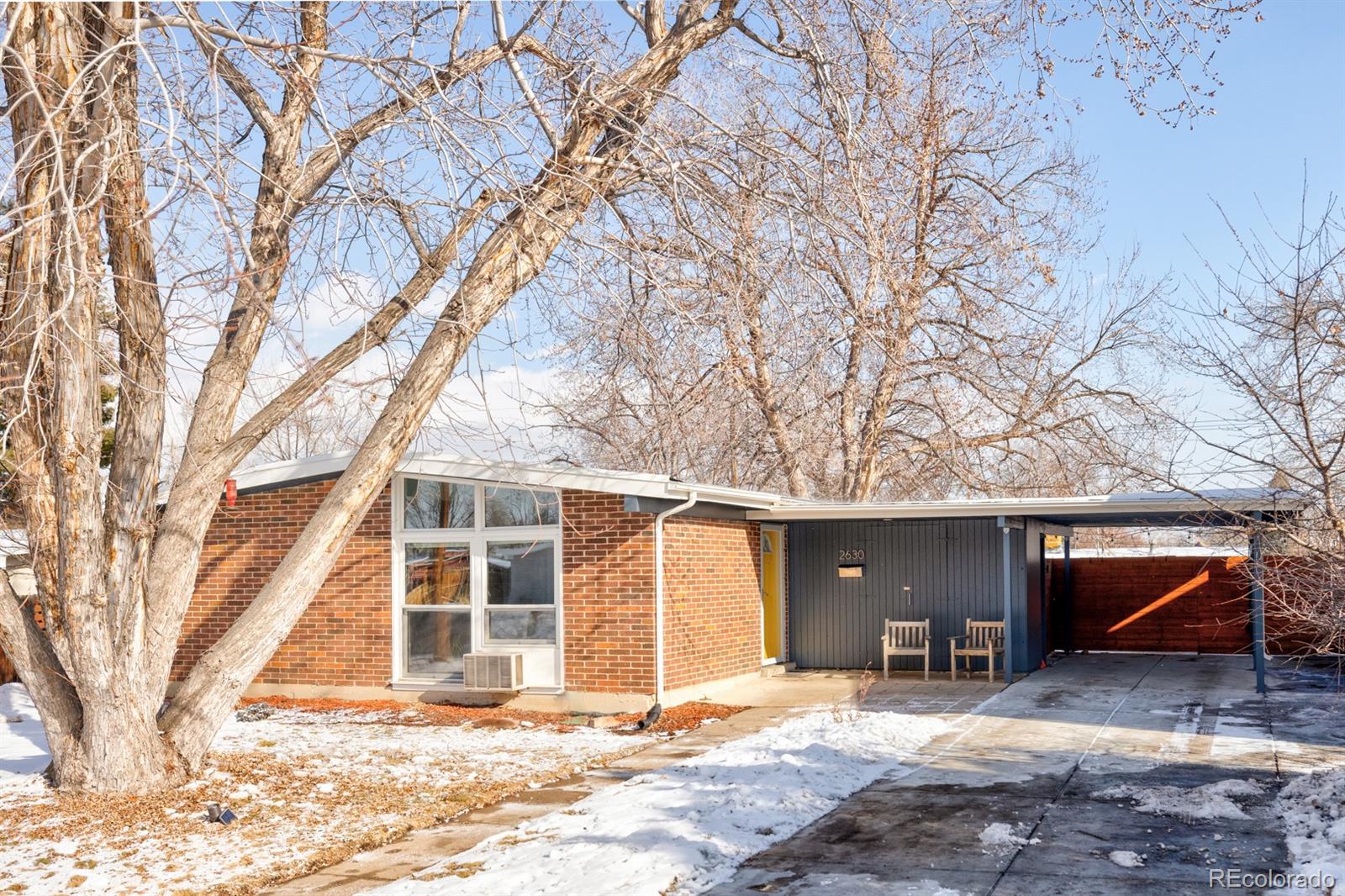 2630 South Perry Street Denver, CO 80219 - Photo 1 of 26 a view of a house with snow in a backyard