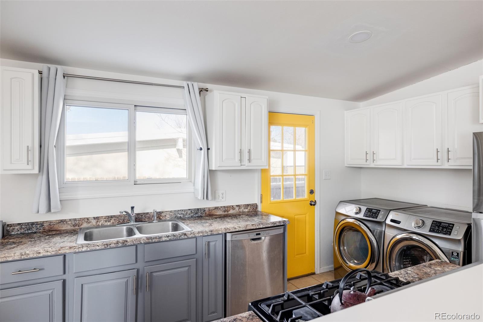 2630 South Perry Street Denver, CO 80219 - Photo 11 of 26 a view of a kitchen with a sink cabinets and a window