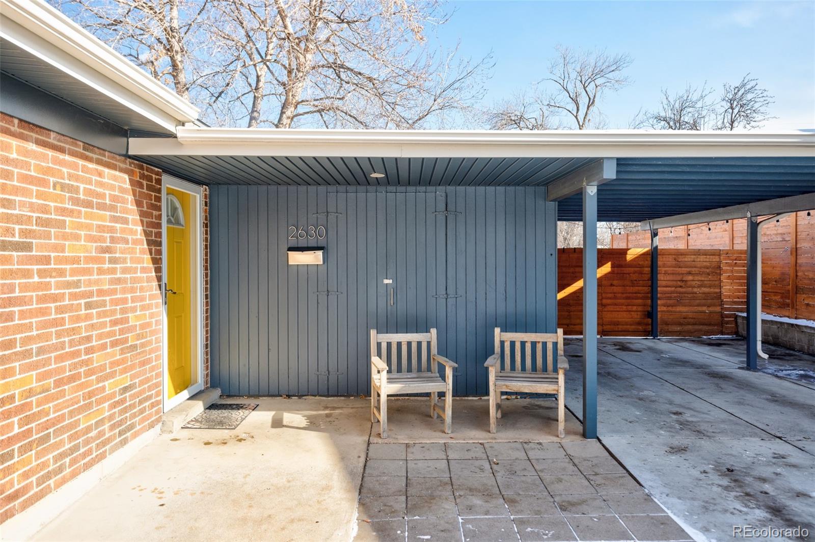 2630 South Perry Street Denver, CO 80219 - Photo 2 of 26 a backyard of a house with a chairs and wooden floor