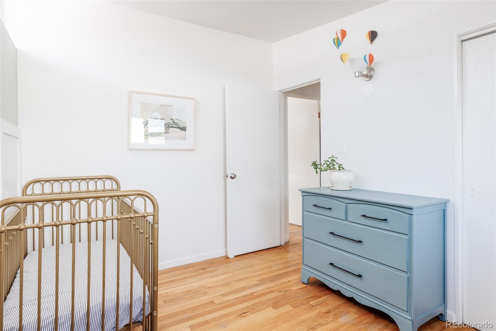 2630 South Perry Street Denver, CO 80219 - Photo 21 of 26 a view of a hallway with wooden floor