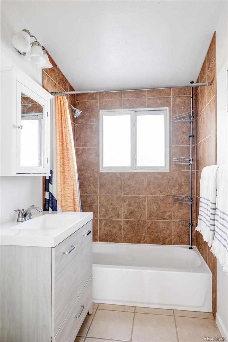2630 South Perry Street Denver, CO 80219 - Photo 22 of 26 a bathroom with a sink and a bathtub