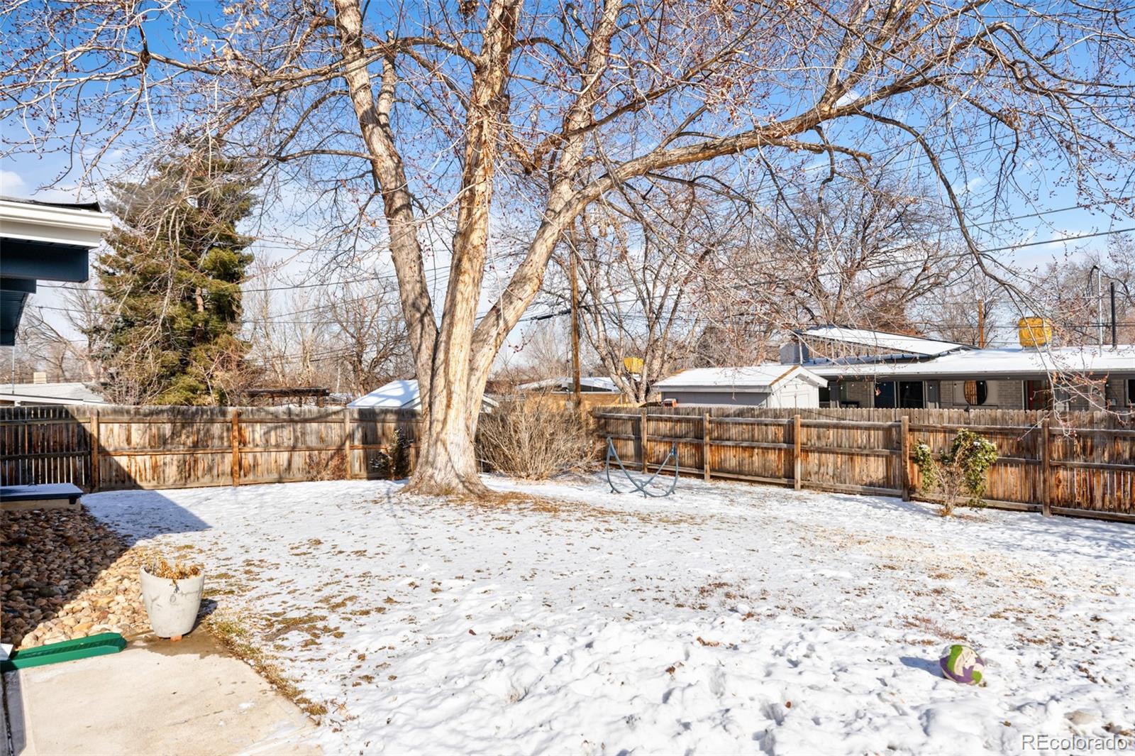 2630 South Perry Street Denver, CO 80219 - Photo 25 of 26 a view of a house with snow on the background