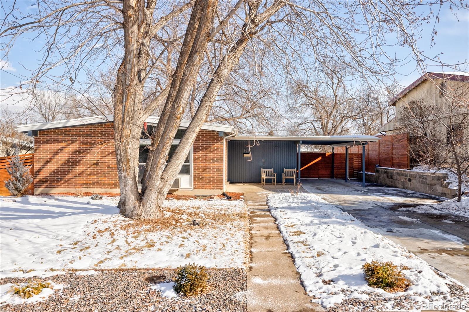 2630 South Perry Street Denver, CO 80219 - Photo 26 of 26 a view of a house with a yard covered in snow