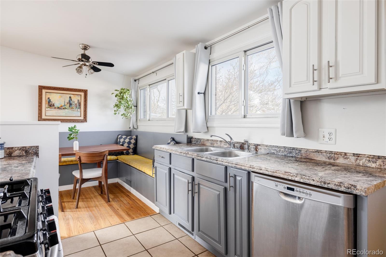 2630 South Perry Street Denver, CO 80219 - Photo 8 of 26 a kitchen with stainless steel appliances granite countertop a sink stove and cabinets