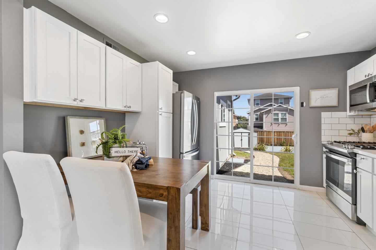 551 Inverness Drive Pacifica, CA 94044 - Photo 11 of 37 a living room with stainless steel appliances furniture a rug and a kitchen view