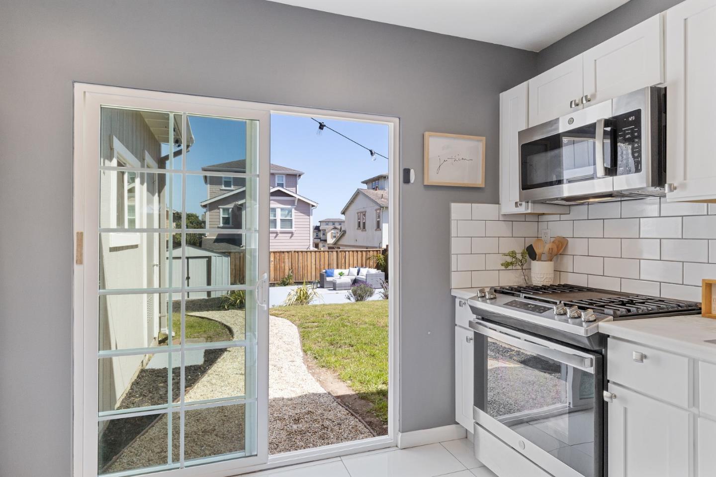 551 Inverness Drive Pacifica, CA 94044 - Photo 13 of 37 a kitchen with stainless steel appliances granite countertop a stove and a sink