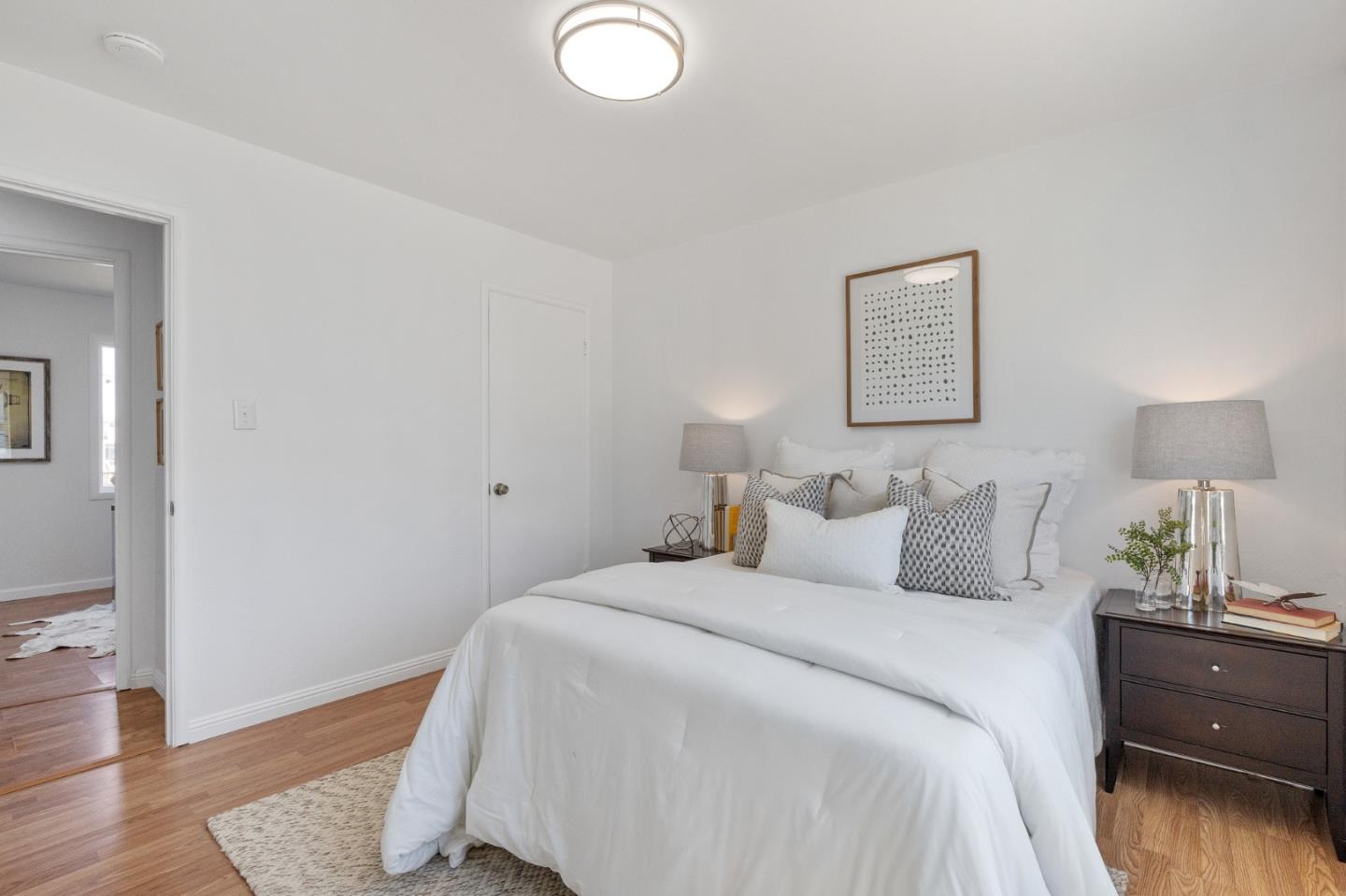 551 Inverness Drive Pacifica, CA 94044 - Photo 20 of 37 a bedroom with a bed and wooden floor