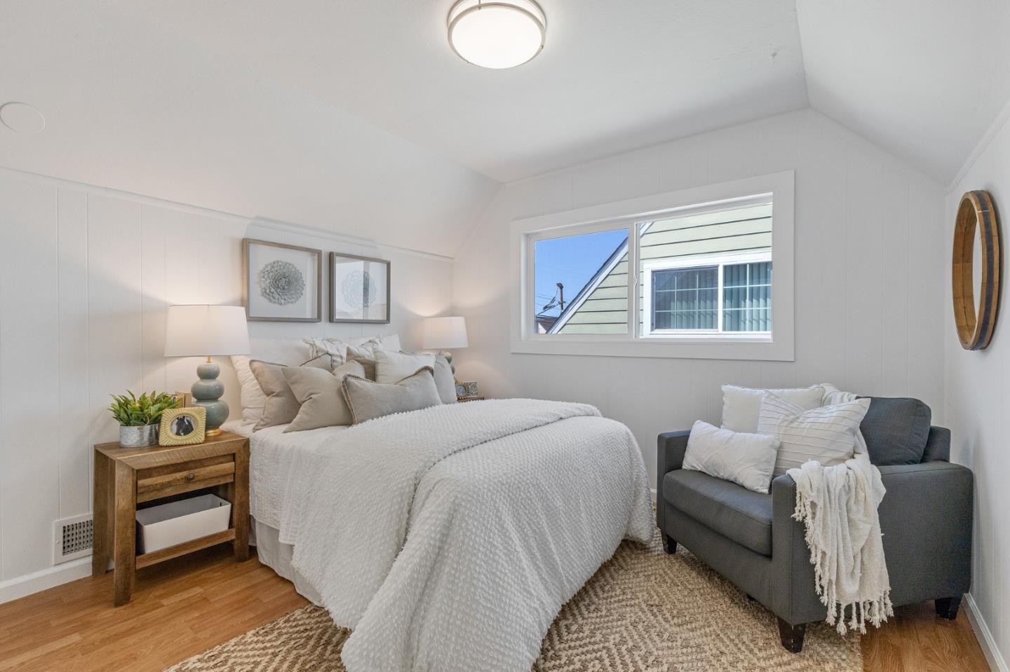551 Inverness Drive Pacifica, CA 94044 - Photo 22 of 37 a bedroom with a bed and wooden floor